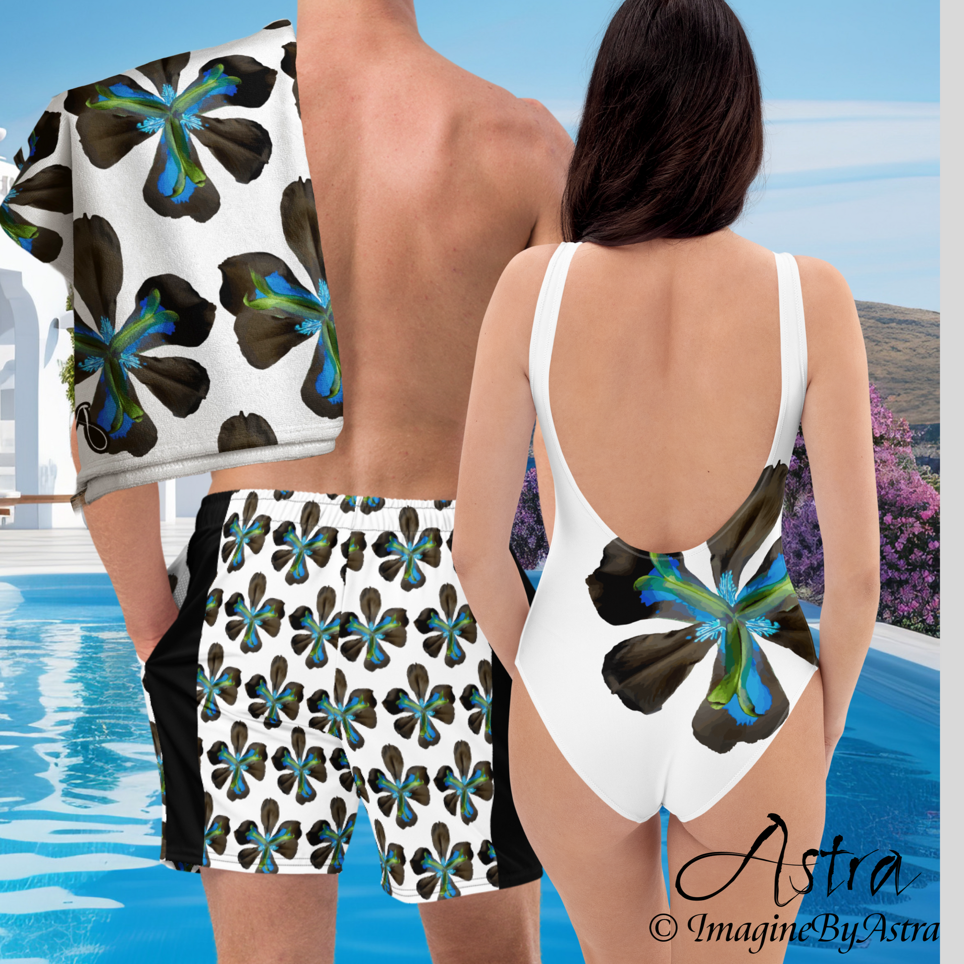 Matching couples swimsuits with blue tropical flower print. A woman wears a women’s white one-piece swimsuit next to a man wearing matching men’s swim trunks, with a resort pool in the background. Part of the Tropical Iris swimwear collection from Imagine by Astra