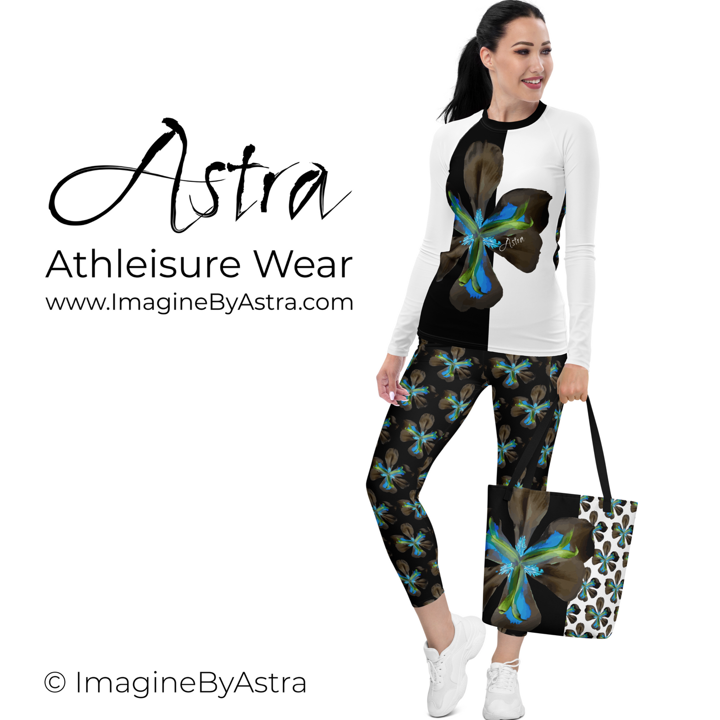 A light skinned woman wears the Tropical Iris Eco-Friendly Leggings in black featuring the electric blue iris flower print. She also wears the matching long sleeved top in white bearing the iris in a single large striking graphic on the front. She is carrying the Astra Tote which features the same bold iris print. Together it is a stunning cohesive ensemble from the Tropical Iris Resort Collection by Imagine by Astra. The logo is featured prominently over the words Athleisure Wear and website listed, www.Im